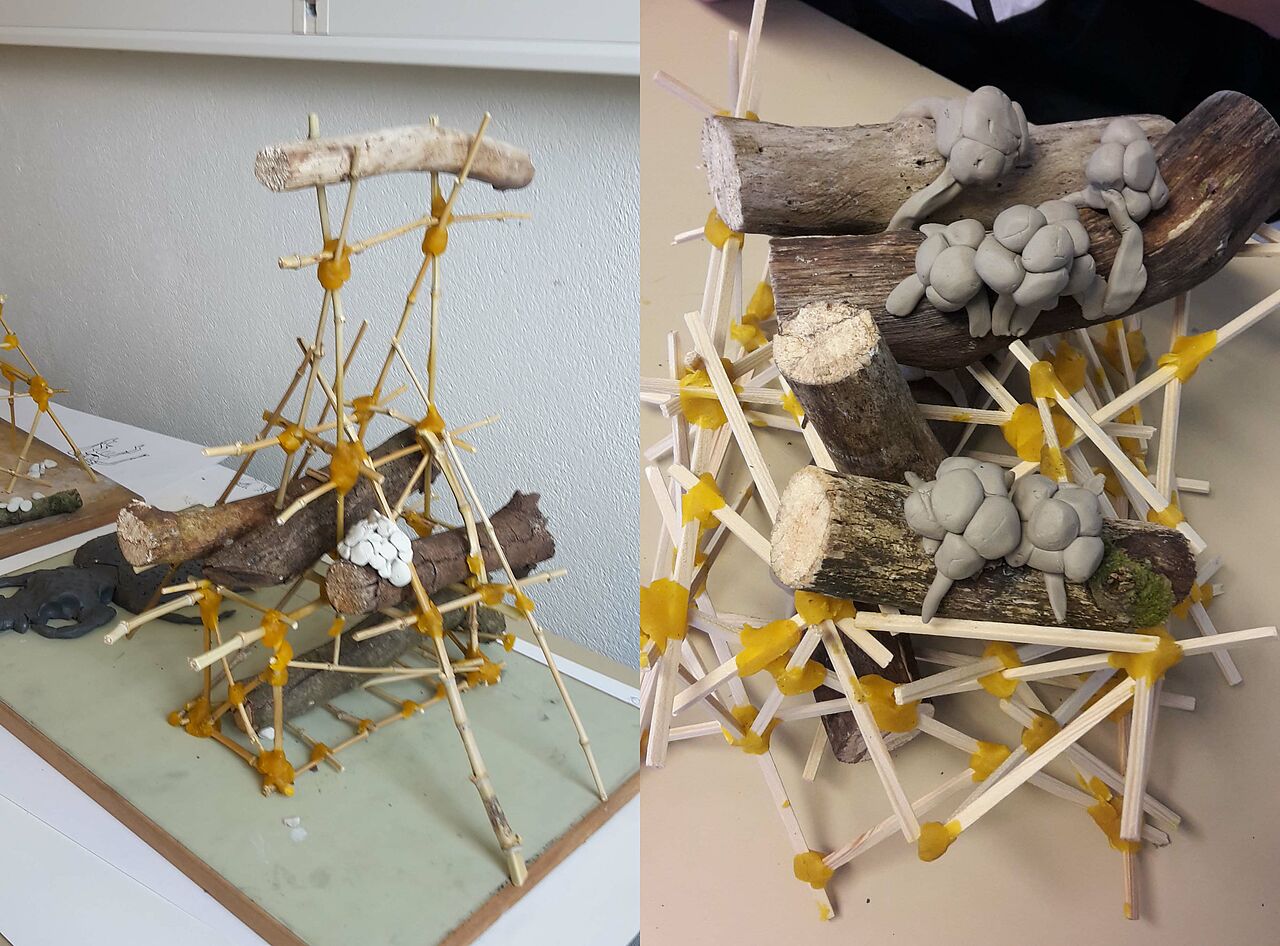 Deux maquettes composées de morceaux de bois et de formes en argiles soutenues par un assemblage de batonnets en bois.